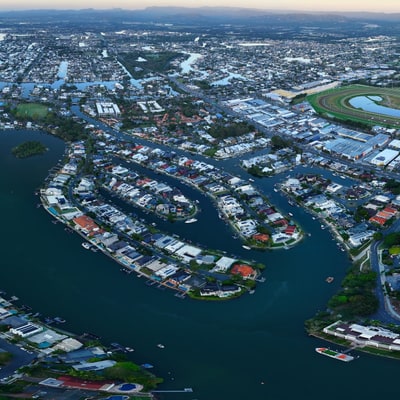 A panoramic view of a city skyline at sunrise over waterways.